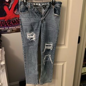 Blue jeans with ripped knees with bandana covering